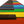 A close-up, angled view of a piano keyboard with brightly colored keys in red, orange, yellow, green, blue, purple, and black, shown against a white background.